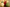Three decorative ornaments in white, red, and green with ribbons on a reflective surface.