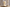 Candle shaped like a classical bust on a reflective surface with a blurred background
