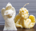 Close-up of the Angelic Love candle, showcasing its delicate wings, flowing robes, and symbolic heart detail.