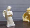 Sculptural angel-shaped candle, blending spiritual symbolism with artisanal craftsmanship for a peaceful ambiance.