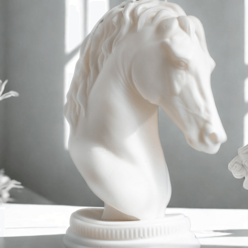 White horse bust candle sculpture on a light surface with a neutral background