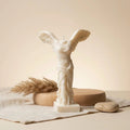 Winged Victory candle lit – classical Greek soy wax sculpture, glowing