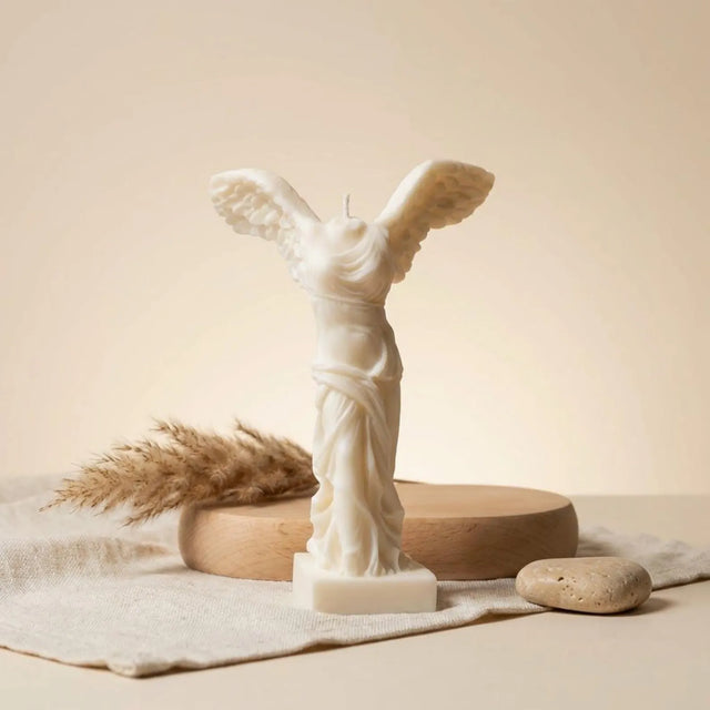 Winged Victory candle lit – classical Greek soy wax sculpture, glowing