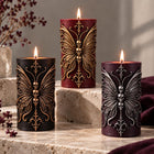 Gothic butterfly pillar candle with sculpted skulls – soy wax sculptural candle
