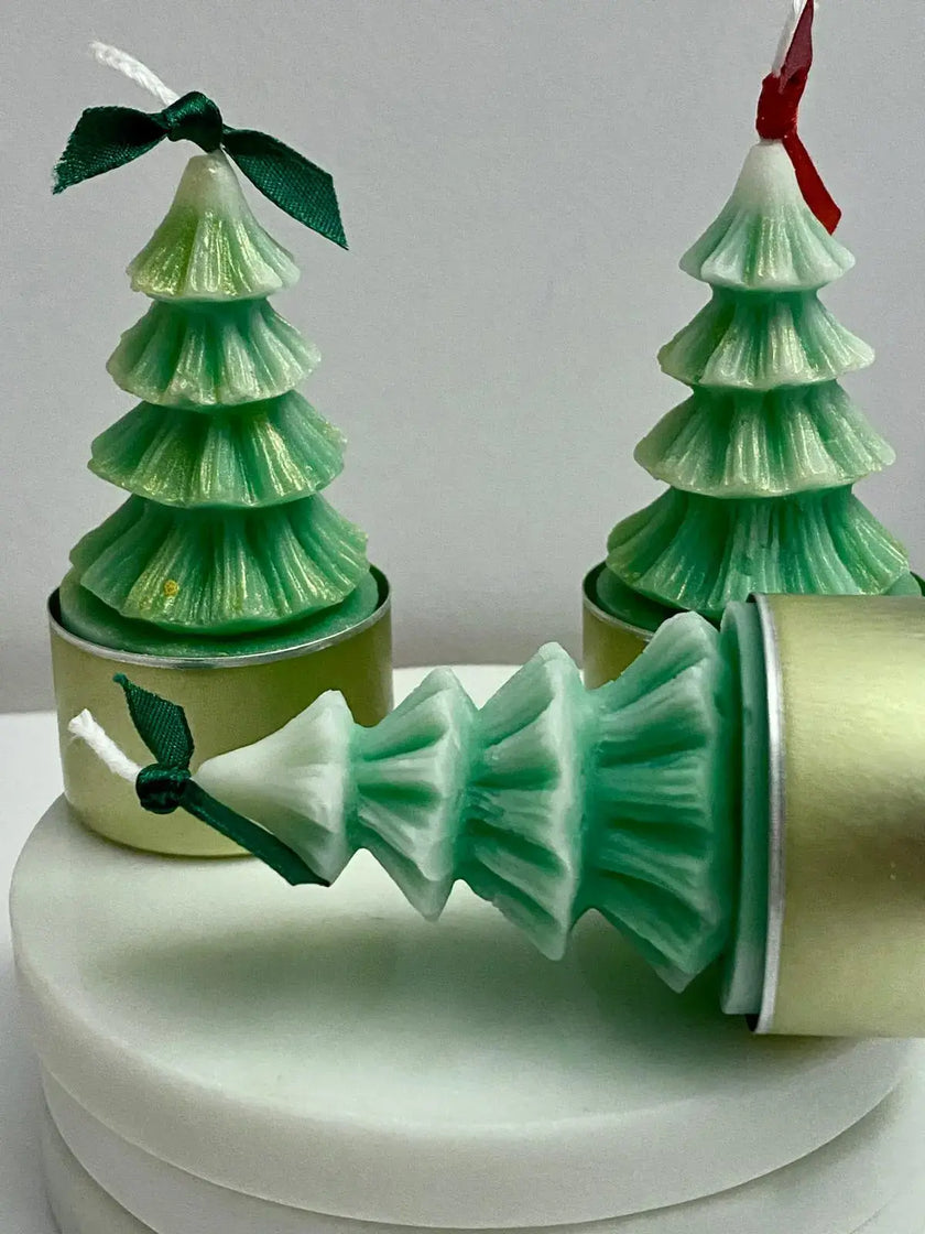 Hand-poured, non-toxic soy wax tealight candles in the form of Christmas trees, ideal for sustainable holiday decor.