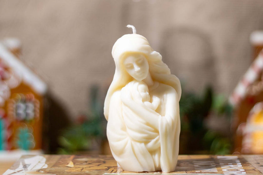 Handcrafted decorative nativity candle depicting a serene mother holding her child, made from natural soy wax.