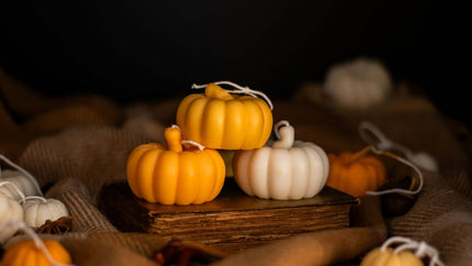 Artisan pumpkin-shaped candle, adding a cozy and festive touch to home interiors during autumn.