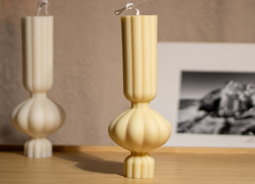 Minimalist pillar-shaped scented candle, blending eco-friendly materials with a soothing aroma for relaxation.