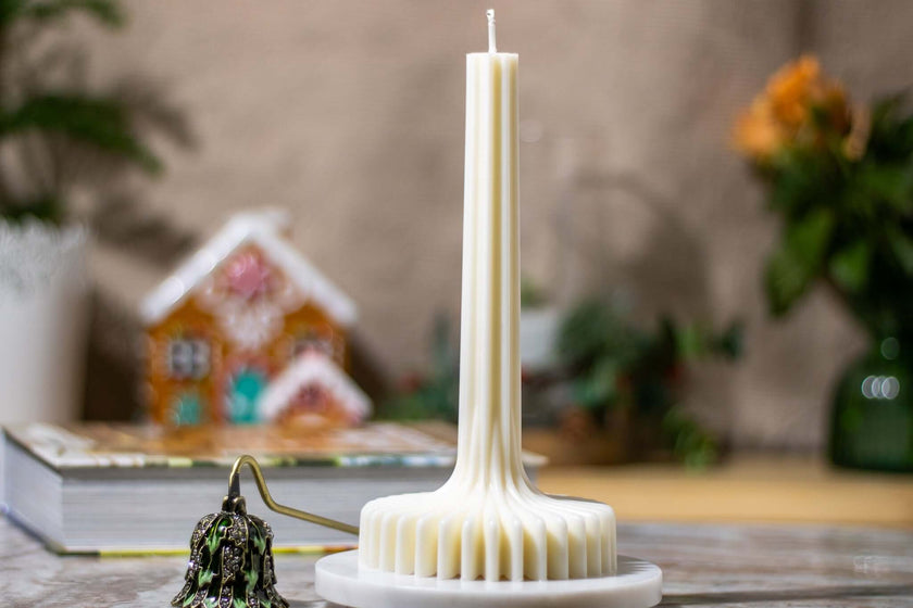 Elegant white candle with unique design, perfect for festive ambiance and holiday decor.