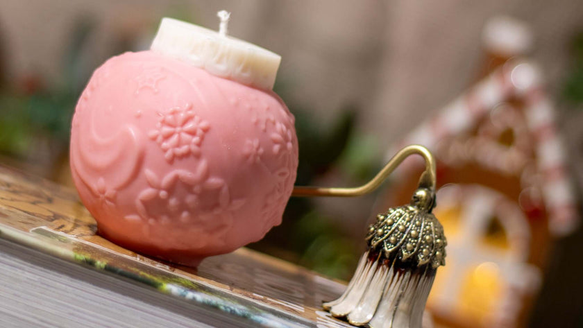 Christmas-themed soy wax candle in a unique globe shape, decorated with intricate snowflake patterns for a magical holiday touch.