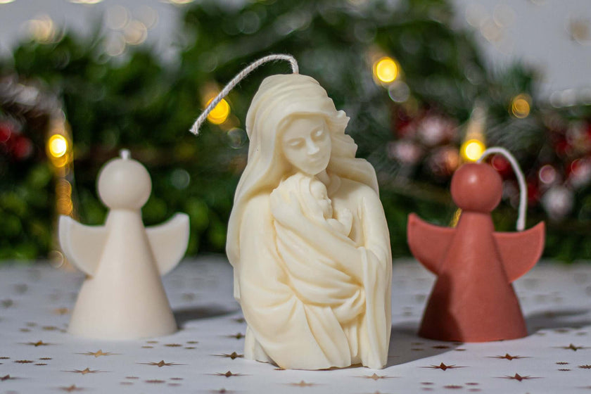 Handcrafted nativity candles featuring a mother holding a child, surrounded by angel-shaped candles, perfect for decor.