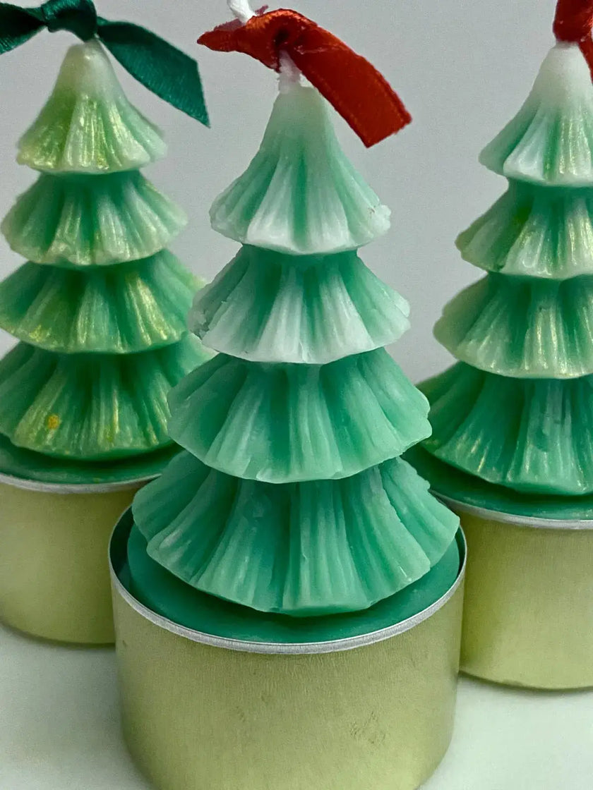 Set of natural soy wax tealight candles, shaped like festive Christmas trees, perfect for creating a warm holiday atmosphere.