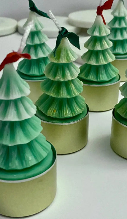Set of eco-friendly Christmas tree-shaped tealight candles made from natural soy wax, perfect for festive decor.