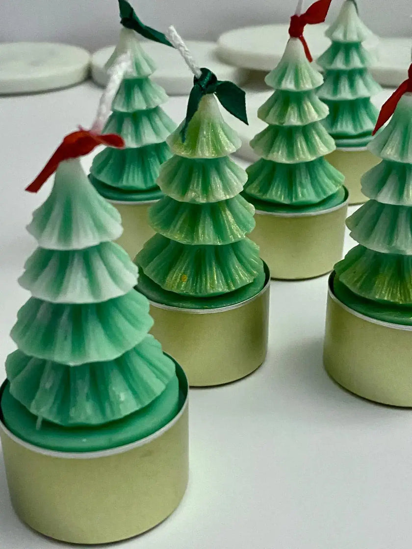 Set of eco-friendly Christmas tree-shaped tealight candles made from natural soy wax, perfect for festive decor.