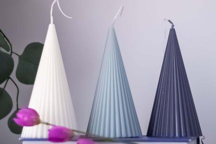 Cone soy wax candles in white, blue, and navy, showcasing elegant handmade design and natural materials.