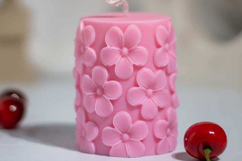 Natural soy wax candle in pink with cherry blossom designs, perfect for a floral-themed ambiance.