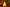 Decorative candle shaped like a Christmas tree with festive decorations in the background.
