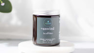 Close-up of soy wax candle with a cotton wick emitting a calming aroma.